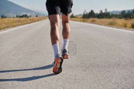 Photo for A highly motivated marathon runner displays unwavering determination as he trains relentlessly for his upcoming race, fueled by his burning desire to achieve his goals. - Royalty Free Image