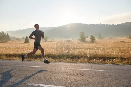 Photo for An athletic man exudes determination as he runs, embodying a commitment to a healthy lifestyle and preparation for an upcoming marathon competition - Royalty Free Image