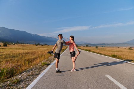 Photo for As dawn breaks, a romantic couple engages in a gentle stretch together, symbolizing their shared dedication and preparation for an invigorating early morning run. - Royalty Free Image