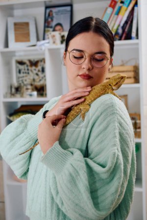 Photo for A beautiful woman in a joyful moment, posing with her adorable bearded dragon pets, radiating love and companionship. - Royalty Free Image