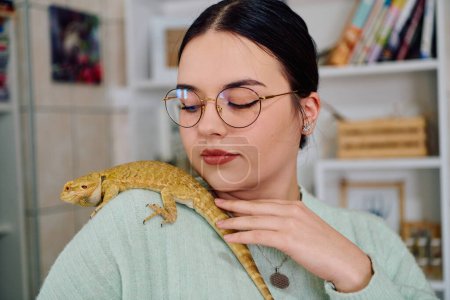 Photo for A beautiful woman in a joyful moment, posing with her adorable bearded dragon pets, radiating love and companionship. - Royalty Free Image