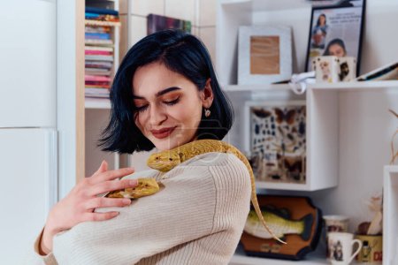 Photo for A beautiful woman in a joyful moment, posing with her two adorable bearded dragon pets, radiating love and companionship. - Royalty Free Image