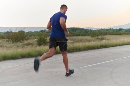 A highly motivated marathon runner displays unwavering determination as he trains relentlessly for his upcoming race, fueled by his burning desire to achieve his goals. 