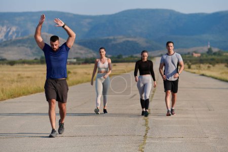 Photo for A group of friends maintains a healthy lifestyle by running outdoors on a sunny day, bonding over fitness and enjoying the energizing effects of exercise and nature. - Royalty Free Image