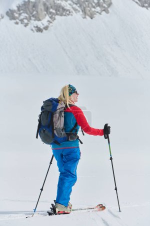 Photo for A determined skier scales a snow-capped peak in the Alps, carrying backcountry gear for an epic descent - Royalty Free Image