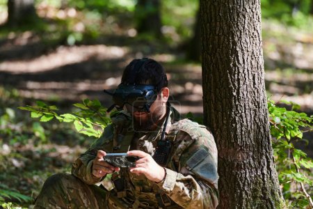 Un soldado de élite, equipado con gafas VR de última generación, maniobra hábilmente un dron militar, mostrando la integración perfecta de la tecnología de vanguardia en la guerra moderna.