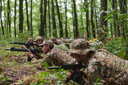 Elite soldiers stealthily maneuver through the dense forest, camouflaged in specialized gear, as they embark on a covert and strategic military mission. 