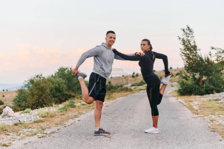 Photo for A romantic couple stretches after a tiring morning run - Royalty Free Image