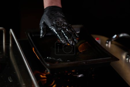 Photo for Close-up shot, a professional chef expertly prepares a delicious steak using modern cooking techniques, showcasing culinary excellence and precision in the art of gourmet cuisine. - Royalty Free Image
