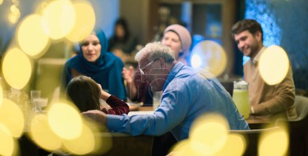 Grandparents arrive at their childrens and grandchildrens gathering for iftar in a restaurant during the holy month of Ramadan, bearing gifts and sharing cherished moments of love, unity, and
