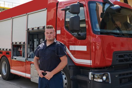 A confident firefighter strikes a pose in front of a modern firetruck, exuding pride, strength, and preparedness for emergency response.