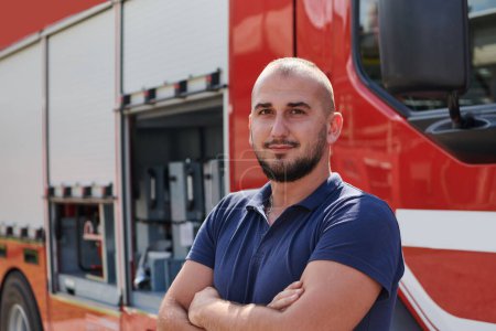 Confident firefighter stands with crossed arms, exuding resilience and preparedness, ready to respond to emergencies alongside a modern fire truck, showcasing the heroism and strength of the fire