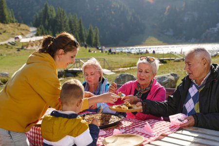 A family on a mountain vacation indulges in the pleasures of a healthy life, savoring traditional pie while surrounded by the breathtaking beauty of nature, fostering family bonds and embracing the