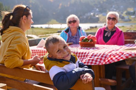 A family on a mountain vacation indulges in the pleasures of a healthy life, savoring traditional pie while surrounded by the breathtaking beauty of nature, fostering family bonds and embracing the