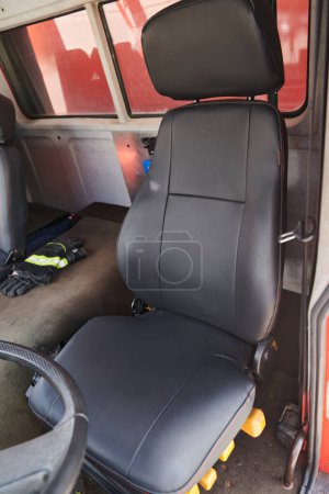 The close-up capture reveals the intricate details of the ergonomic seats and high-tech interior of a modern firefighting truck, showcasing a perfect blend of functionality and safety features. 