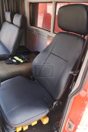 Die Nahaufnahme offenbart die komplexen Details der ergonomischen Sitze und des Hightech-Interieurs eines modernen Feuerwehrfahrzeugs, die eine perfekte Mischung aus Funktionalität und Sicherheitsmerkmalen darstellen.. 