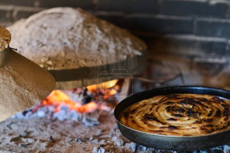 Capturing the essence of Bosnian culinary tradition, step-by-step preparation of a traditional Bosnian pie, showcasing the meticulous craftsmanship and authentic flavors involved in the culinary
