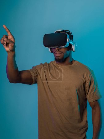 Immersed in a digital realm, an African American man navigates the virtual landscape with a VR goggles, using tactile gestures to interact with virtual objects, showcasing a harmonious blend of