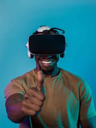 African American man wearing virtual reality glasses expresses satisfaction and impressed delight, gesturing with his hand pointed upward, while standing isolated against a vibrant yellow background