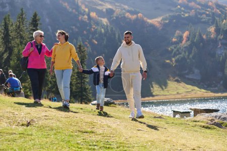A family shares delightful moments with their friends amid the stunning landscapes of mountains, lakes, and winding paths, promoting a healthy lifestyle and the joy of familial bonds in the embrace of