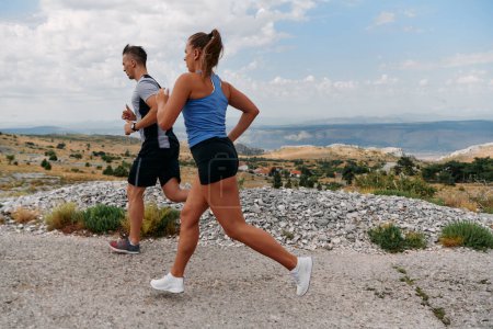  Couple conquer challenging mountain trails during an invigorating morning run.