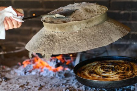 Photo for Capturing the essence of Bosnian culinary tradition, step-by-step preparation of a traditional Bosnian pie, showcasing the meticulous craftsmanship and authentic flavors involved in the culinary - Royalty Free Image