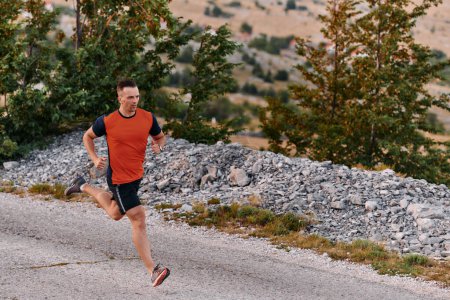A muscular male athlete runs along a rugged mountain path at sunrise, surrounded by breathtaking rocky landscapes and natural beauty. 