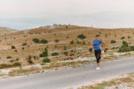 A determined female athlete stretches her muscles after a strenuous run through rugged mountain terrain, surrounded by breathtaking rocky landscapes. 