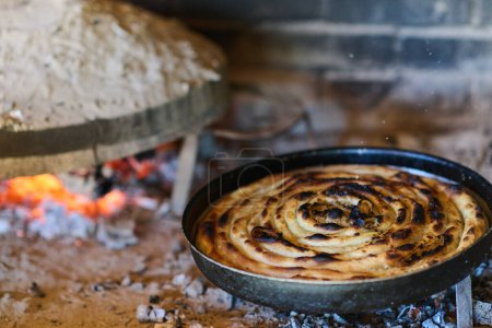 Photo for Capturing the essence of Bosnian culinary tradition, step-by-step preparation of a traditional Bosnian pie, showcasing the meticulous craftsmanship and authentic flavors involved in the culinary - Royalty Free Image