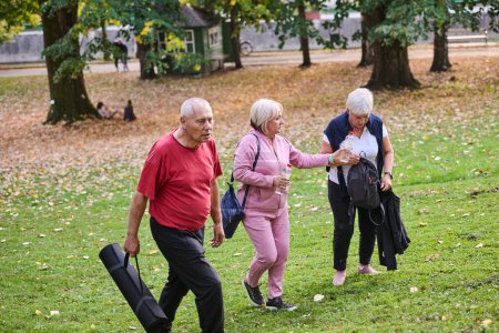 A group of senior friends takes a well-deserved break in nature, fostering not only fitness but also camaraderie and a shared commitment to maintaining a healthy and active lifestyle in their golden