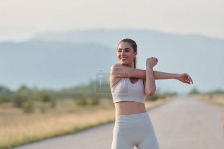 A determined athletic woman engages in post-run stretching, epitomizing dedication to her fitness journey and nurturing her bodys flexibility and well-being