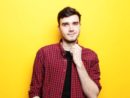 Photo for Young handsome fashionable male model standing against yellow background - Royalty Free Image