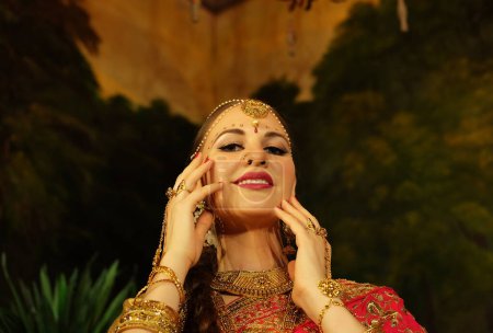 Foto de Retrato de una hermosa hembra india. Joven modelo hindú en sari y joyería kundan. Traje tradicional de la India lehenga choli. Cultura oriental, musulmana o árabe. - Imagen libre de derechos