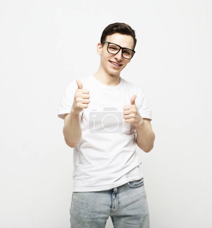 Photo for Young happy man feeling proud, carefree, confident and happy, smiling positively with thumbs up - Royalty Free Image