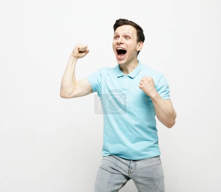 Photo for Young man wearing casual clothes celebrating surprised and amazed for success with arms raised and open eyes. Winner concept. - Royalty Free Image