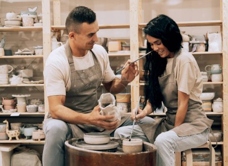 Photo for Couple in love working together on potter wheel in craft studio workshop. Lifestyle cocnept. - Royalty Free Image