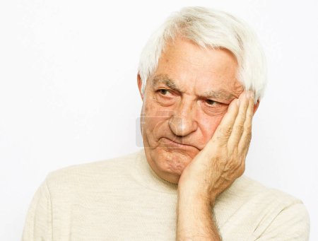 Photo for Lifestyle, health and old people concept: Portrait of an old man having a toothache against white background, close up - Royalty Free Image