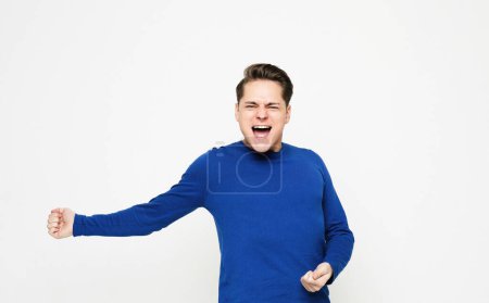 Photo for Lifestyle and emotion concept: Happy young handsome man gesturing and keeping mouth open over white background - Royalty Free Image