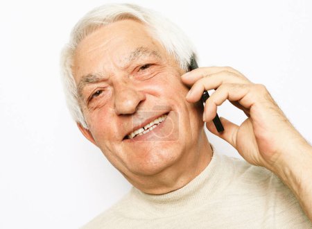 Photo for Technology, senior people, lifestyle and communication concept - close up of happy old man using smartphone over white background. Talking to friends or family. - Royalty Free Image