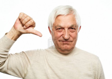 Photo for Emotion, old people and body language concept: Senior man standing over isolated white background looking unhappy and angry showing rejection and negative with thumbs down gesture. - Royalty Free Image