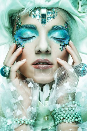 Photo for Party, christmas and people concept: Beautiful young woman with bright creative make-up in New Year's costume posing with her eyes closed, close-up portrait. - Royalty Free Image