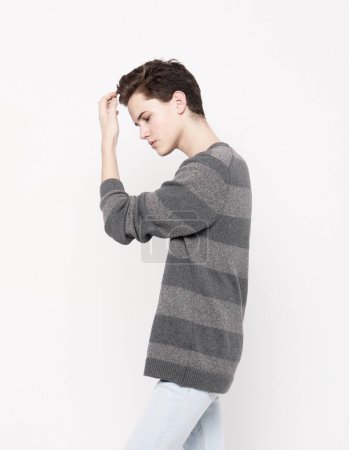 Foto de Young handsome teenage hipster guy wearing casual sweater posing against white background isolated, lifestyle people concept - Imagen libre de derechos