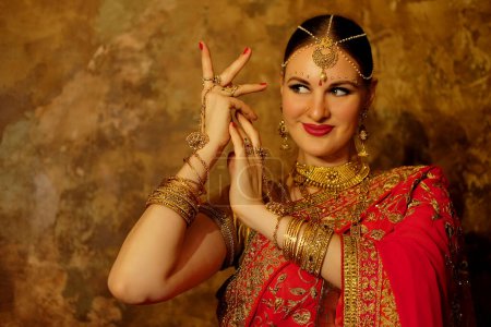 Foto de White beautiful woman is dancing in traditional indian dress - Imagen libre de derechos