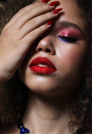 Foto de Fashion and beauty concept: attractive young african american woman with bright make up with closed eyes, close up portrait - Imagen libre de derechos