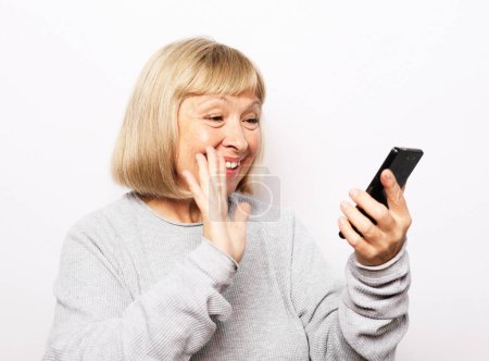 Photo for Portrait of her she nice attractive lovely pretty fashionable cheerful cheery grey-haired woman taking making selfie spending free time isolated over white background. Lifestyle and tehnology concept. - Royalty Free Image