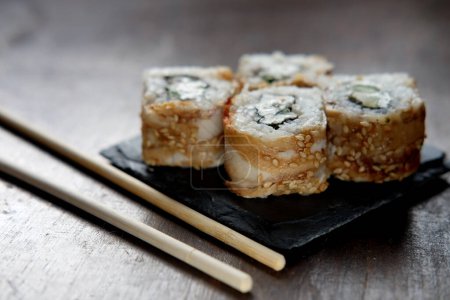 Photo for Japanese food rolls with fish and avocado. Close up. - Royalty Free Image