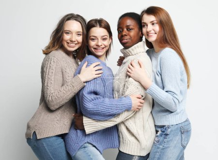 Photo for Portrait of charming multiracial female friends over light grey background. Lifestyle, friendship and people concept. - Royalty Free Image