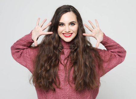 Photo for Lifestyle, emotion and young people concept: charming smiling young woman with long dark hair dressed pink sweater - Royalty Free Image