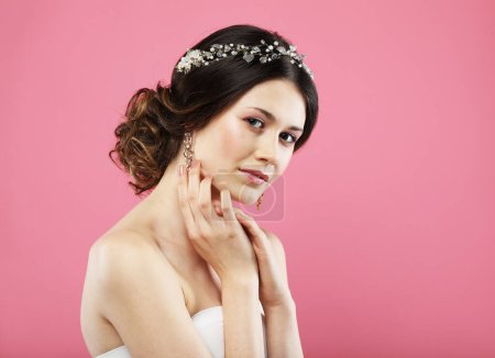 Foto de Jewelry, luxury, wedding and people concept: young bride with gorgeous diadem in her hair. Portrait over pink color background. - Imagen libre de derechos