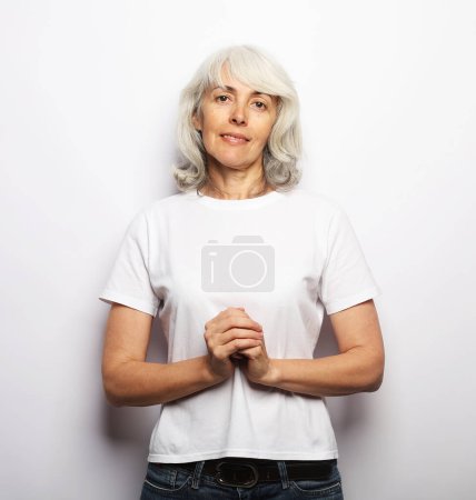 Téléchargez les photos : Happy elderly female with white hair smiling over white background, close up - en image libre de droit